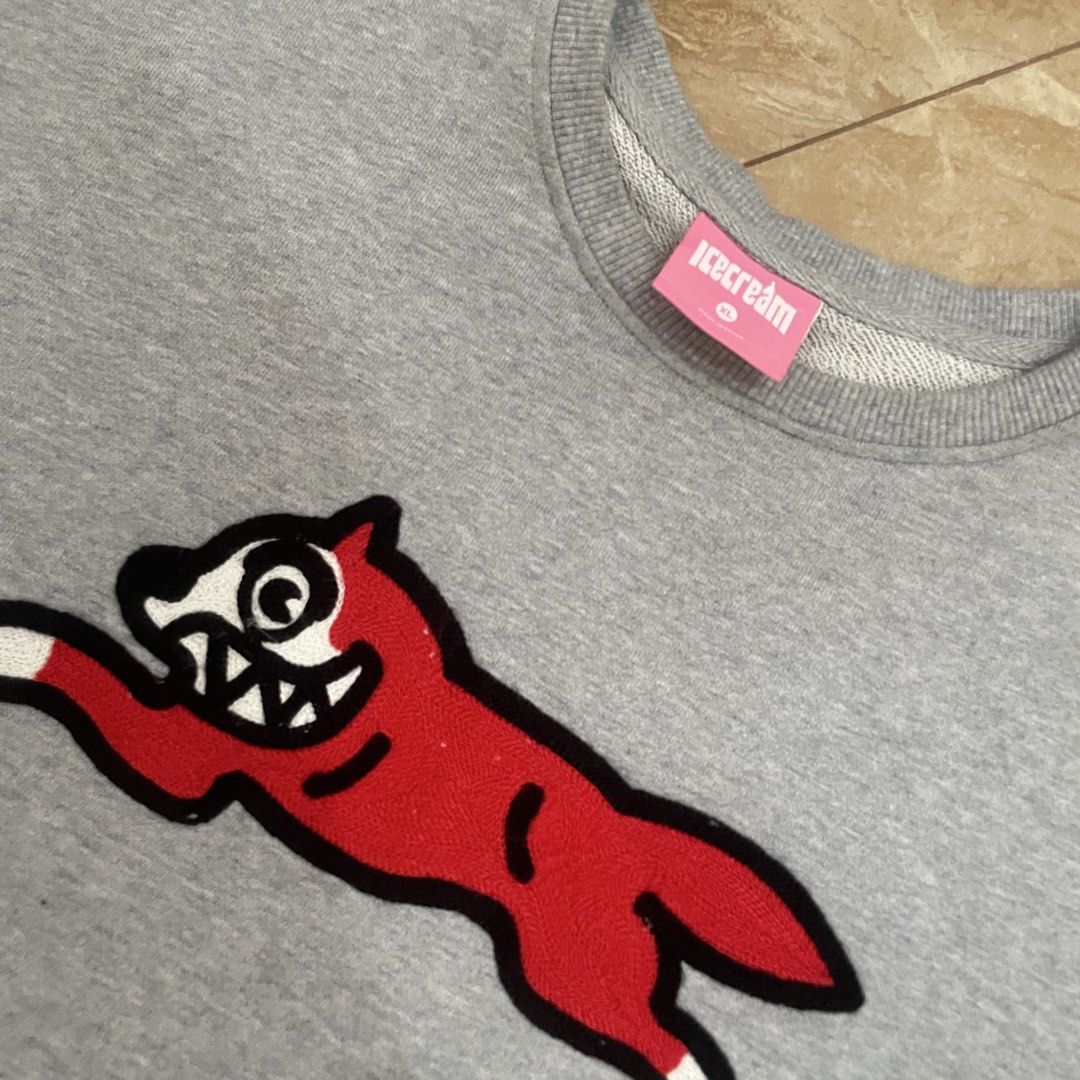 Icecream Running Dog Sweatshirt (Category: Coats, Jackets and Outerwear) located in Cavite. Submitted by rawbeentherefore (Listing ID 1432282880, Image 2). Description: - Gray Icecream sweatshirt - Features a red running dog graphic - Crew neck - Long sleeves - Icecream logo on neck tag - Size tag visible.