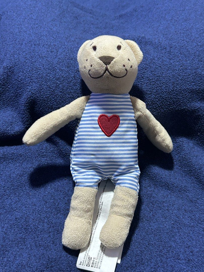 IKEA FABLER BJÖRN soft toy (Category: Plushies & Soft Toys) located in Angeles City. Submitted by zyeplustradings (Listing ID 1432322280, Image 1). Description: IKEA FABLER BJÖRN soft toy Item: Plush teddy bear with a blue striped romper and a red heart appliqué. Dimensions: Approximately 21 cm (8 inches) in height. Design: Features contrasting colors and soft materials, designed for hugging, comforting, and play. Safety: Child-safe construction 