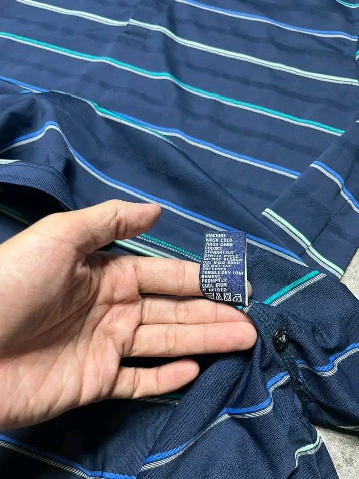 Jack Nicklaus Polo Shirt - Navy Blue (Category: Tshirts & Polo Shirts ) located in Cavite. Submitted by thriftnired (Listing ID 1432309319, Image 2). Description: - Jack Nicklaus Performance polo shirt - Color: Navy blue with horizontal stripes - Features a collared neckline and short sleeves - Jack Nicklaus logo embroidered on the sleeve - Material: 100% polyester - Size: L.