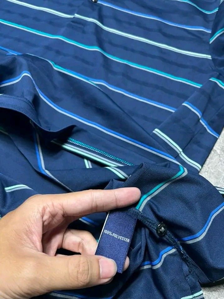 Jack Nicklaus Polo Shirt - Navy Blue (Category: Tshirts & Polo Shirts ) located in Cavite. Submitted by thriftnired (Listing ID 1432309319, Image 3). Description: - Jack Nicklaus Performance polo shirt - Color: Navy blue with horizontal stripes - Features a collared neckline and short sleeves - Jack Nicklaus logo embroidered on the sleeve - Material: 100% polyester - Size: L.
