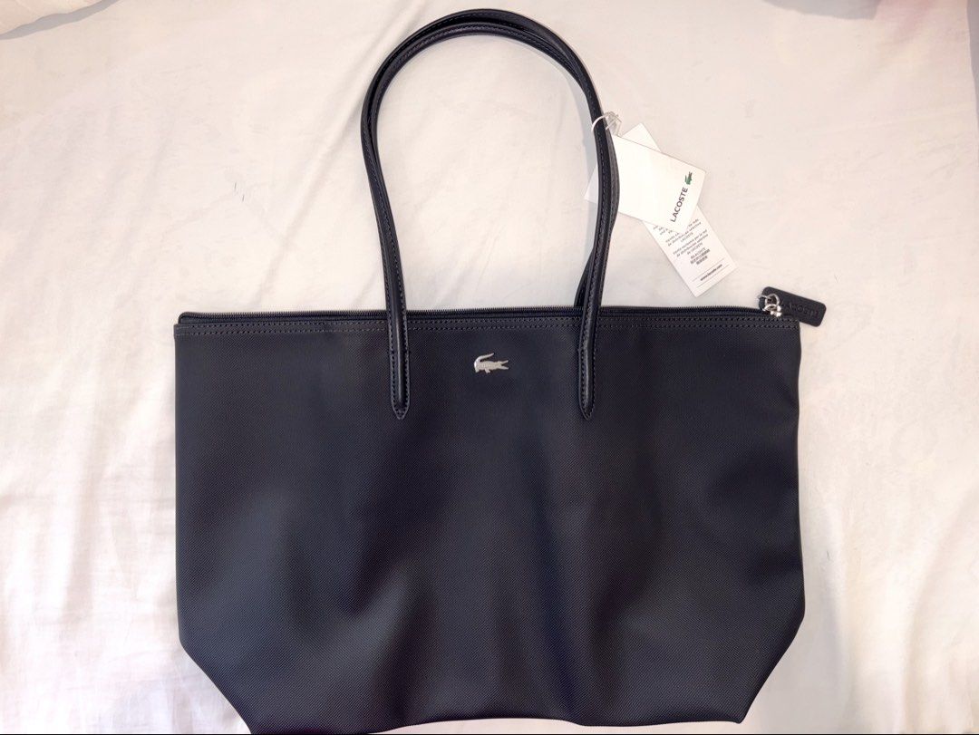Lacoste Shoulder Tote Shopping Bag (Category: Shoulder Bags) located in Paranaque City. Submitted by ymrtn (Listing ID 1432290857, Image 1). Description: 100% PVC Long handle Dimensions L18 x W12 × D5 in - Embroidered Crocodile branding - Zippered - One interior net pocket with hook - Lacoste branded zipper slider RFS: received as a gift I already have.