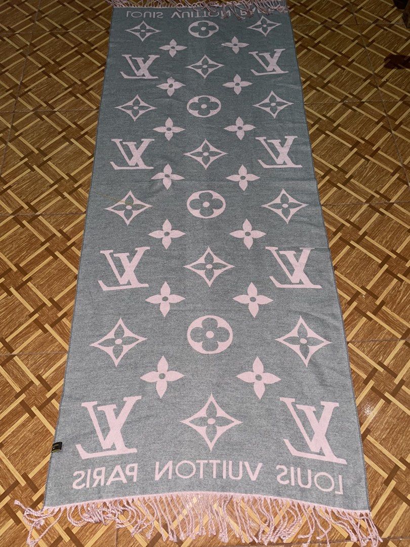 Louis Vuitton Cashmere Silk Scarf (Category: Luxury Accessories) located in Baguio. Submitted by cleverlion_e92944 (Listing ID 1432312359, Image 2). Description: Louis Vuitton scarf is made of 65% cashmere and 35% silk. It features the Louis Vuitton logo and the words "LOUIS VUITTON PARIS". The scarf has a pink and gray color scheme with fringe detailing on the edges. It is reversible, with a different color scheme on each side..