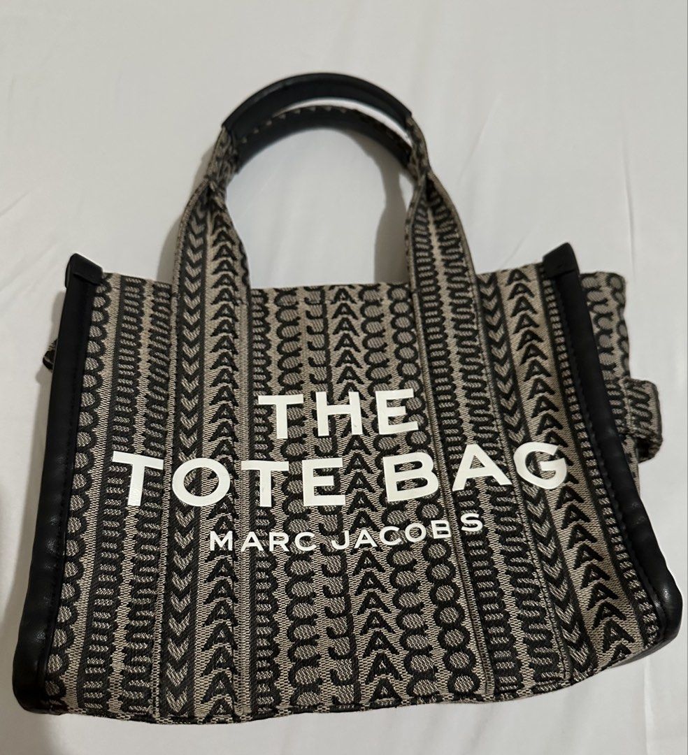 Marc Jacobs The Tote Bag (Category: Luxury Bags & Wallets) located in Cagayan de Oro. Submitted by aquamarine14 (Listing ID 1432283322, Image 1). Description: - Marc Jacobs The Tote Bag - Black and beige jacquard design - Two top handles - Adjustable, detachable shoulder strap - Main compartment with zipper closure - Silver-toned hardware -check photos for flaws .