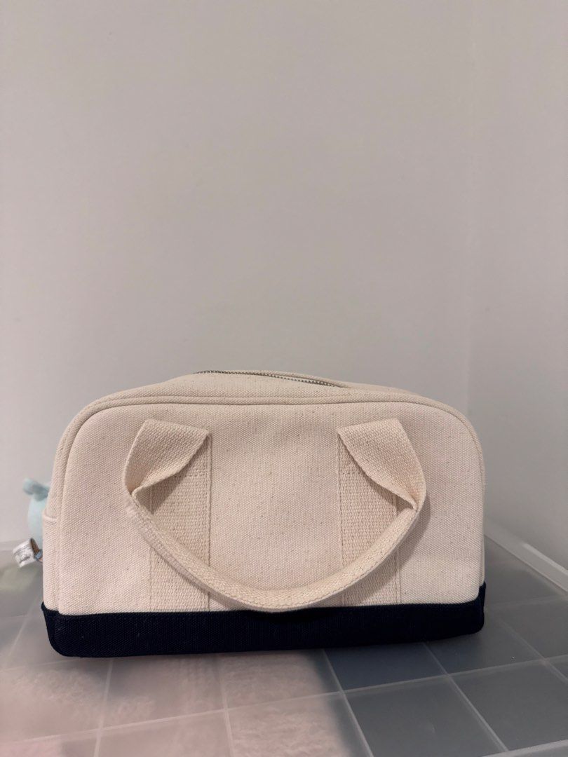 Marithe picnic bag (Category: Shoulder Bags) located in Singapore. Submitted by ellyllelly (Listing ID 1432336437, Image 2). Description: - Korean popular brand - Marithe picnic bag - Off-white color with navy blue base - Features the Marithe logo - Perfect for picnics or everyday use.