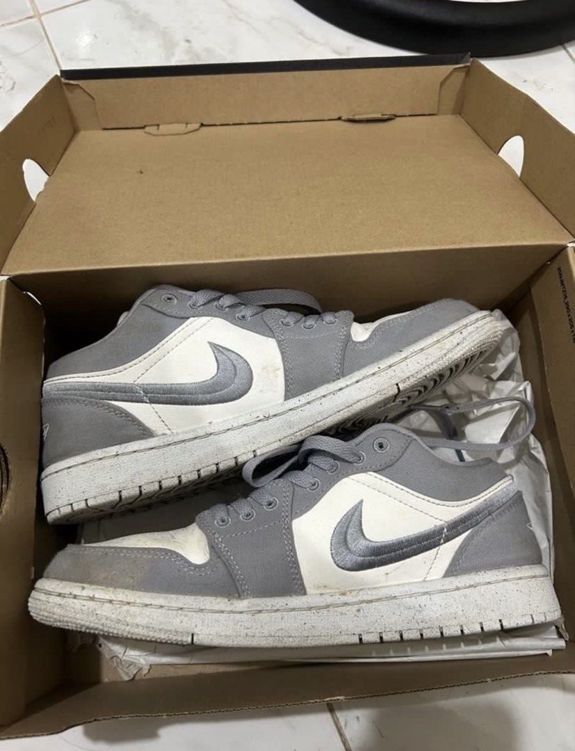 Nike Air Jordan 1 Low (Category: Sneakers) located in Lucena. Submitted by lcndeclutter (Listing ID 1432304182, Image 3). Description: - Nike Air Jordan 1 Low sneakers - Color: Grey and White - Includes original box - Box features "Move to Zero" print - Air Jordan logo on tongue - Iconic Nike swoosh on side 3x lang nasuot.