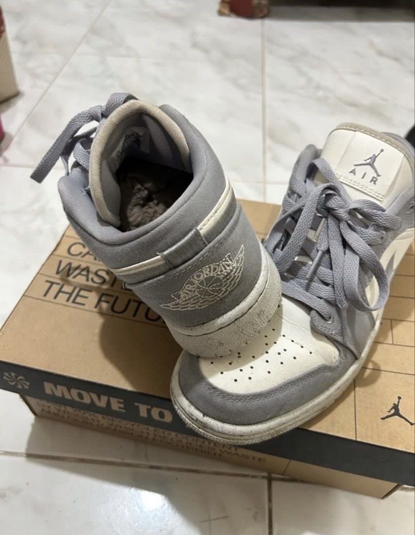 Nike Air Jordan 1 Low (Category: Sneakers) located in Lucena. Submitted by lcndeclutter (Listing ID 1432304182, Image 2). Description: - Nike Air Jordan 1 Low sneakers - Color: Grey and White - Includes original box - Box features "Move to Zero" print - Air Jordan logo on tongue - Iconic Nike swoosh on side 3x lang nasuot.