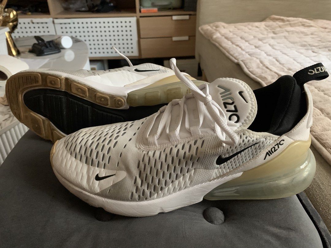 Nike Air Max 270 White Sneakers (Category: Sneakers) located in Quezon City. Submitted by rsalinda (Listing ID 1432251552, Image 2). Description: - Nike Air Max 270 - White colorway - US size 10 - Iconic Air Max bubble heel - Black Nike swoosh logo - Visible signs of wear on soles and uppers - White laces - Insole tag visible in photos.