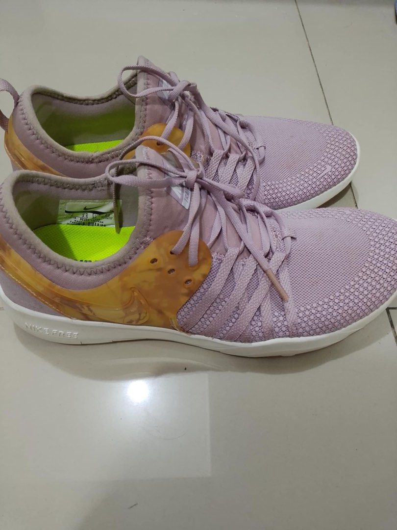 Nike Training Shoes (Category: Sneakers) located in Manila. Submitted by usbrandedcollections (Listing ID 1432201264, Image 2). Description: Onhand ready to ship! Lahat Original Expected minor flaws / stain ❌ NO Refund, swap, return & exchange Color may vary due to lightning - Lavender upper with white sole - Lace-up closure - Heel pull tab - Nike logo on the side - Bright green insole - Designed for training - Flexible sole.