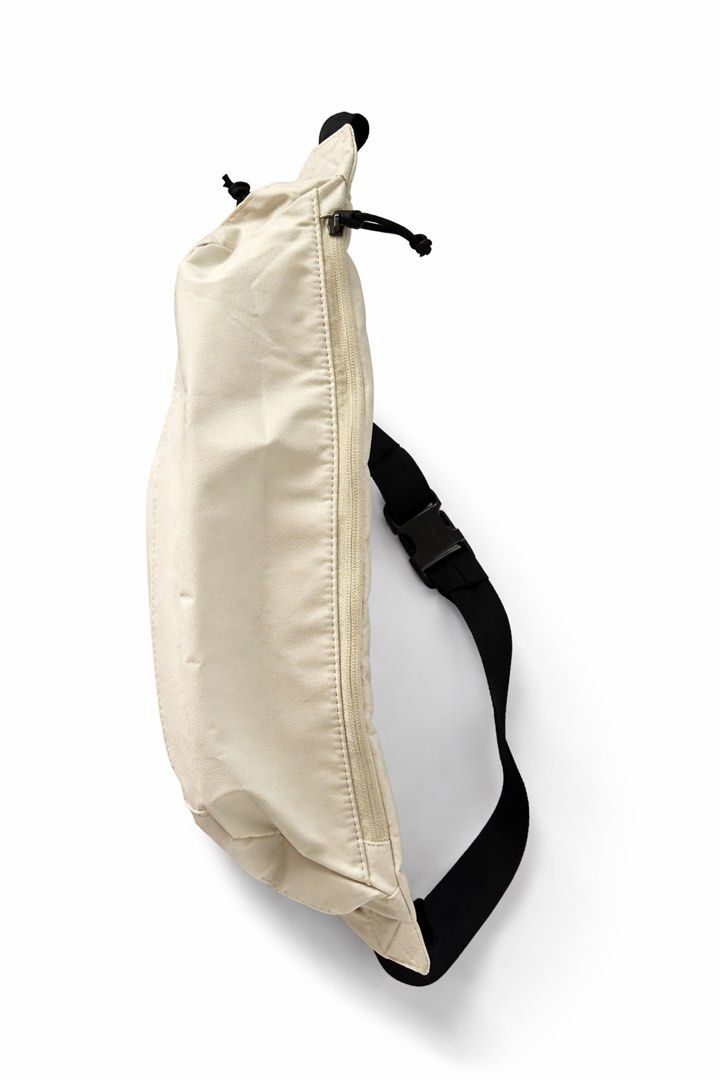 Nike Waist Bag UNISEX (Category: Belt bags, Clutches and Pouches) located in Antipolo. Submitted by cl026 (Listing ID 1432209053, Image 3). Description: - Cream-colored Nike waist bag - Black adjustable strap - Zippered main compartment - Nike logo on the front - Unisex - Capacity: 610 CU IN - Suggested retail price: "$40".