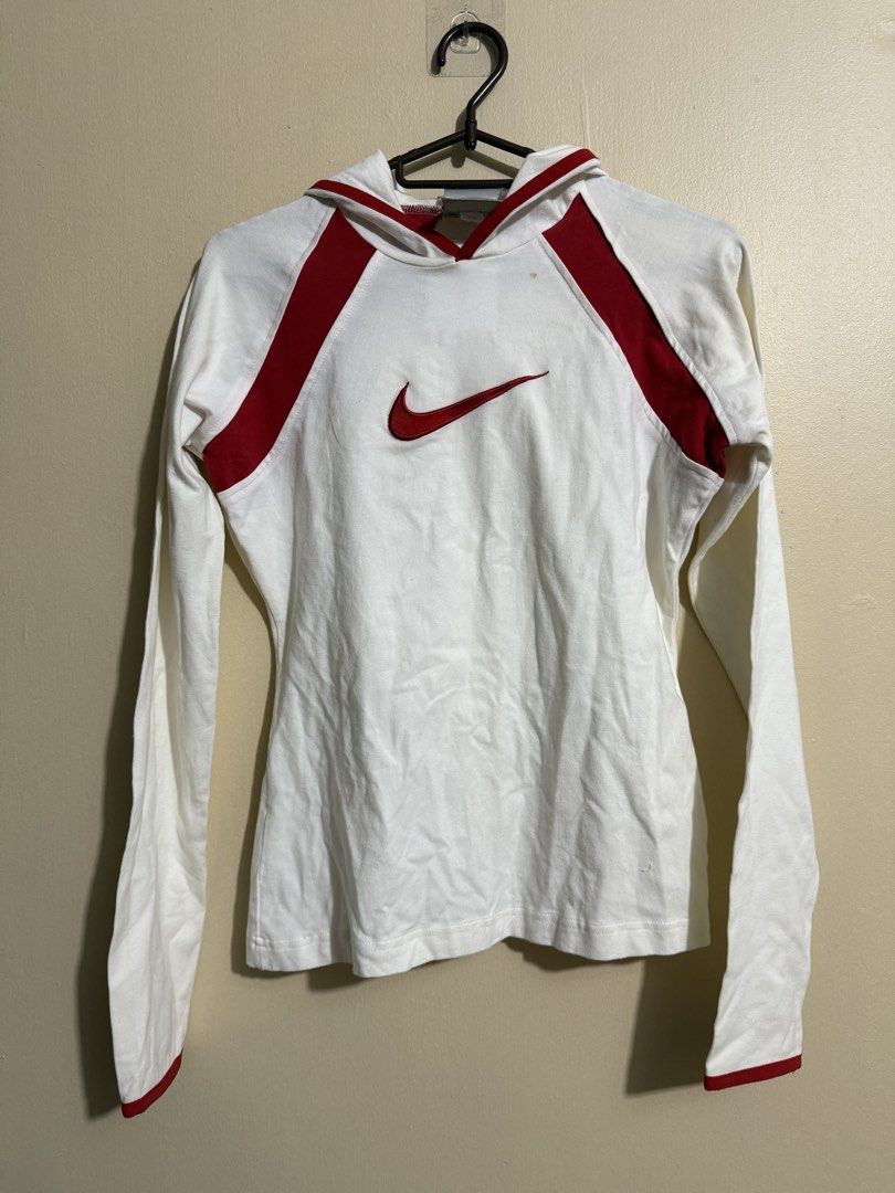Nike White and Red Hoodie (Category: Coats, Jackets and Outerwear) located in Quezon City. Submitted by lau_v (Listing ID 1432377086, Image 1). Description: - White Nike hoodie with red accents - Features Nike logo - Hooded with long sleeves - Red cuffs - Size: M on tag but fits S (body hugging) With stain shown on photo.