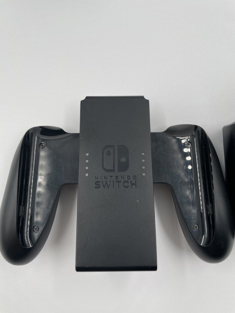 Nintendo Switch Joy-Con Grip (Category: Controllers) located in Caloocan City. Submitted by blvck_rabbit_ph (Listing ID 1432289554, Image 2). Description: - Comfortable Joy-Con grip for Nintendo Switch. - Sleek black finish. - Designed for easy use. - Features a charging dock for Joy-Cons. - Improves gaming comfort and experience. 💰: BPI, Gcash, Maya, Cash - In Person 🚚 : LBC, Lalamove, J & T Express 📍: SM Caloocan & SM Fairview & Meycuayan On