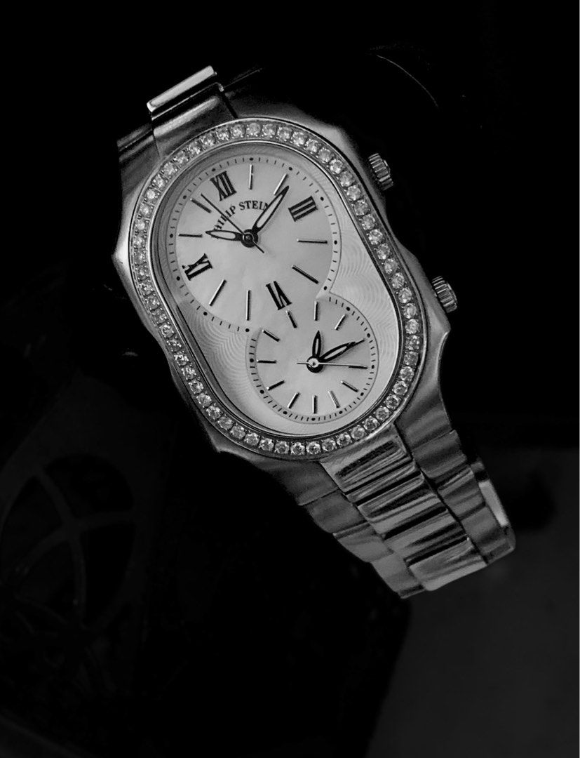Philip Stein Diamond Dual Time Watch (Category: Luxury Watches) located in Muntinlupa City. Submitted by wanderluxesly (Listing ID 1432241346, Image 3). Description: - Philip Stein dual time watch - Silver-tone stainless steel bracelet and case - White dial with Roman numeral hour markers - Diamond accents on the bezel - Two separate dials for timekeeping - Features two pushers - A stylish accessory -Mother of Pearl.