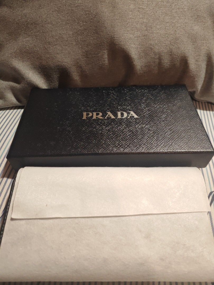 Prada Black Zip Around Wallet (Category: Luxury Bags & Wallets) located in Caloocan City. Submitted by rijentolio24393 (Listing ID 1432344106, Image 1). Description: - Authentic Prada wallet - Black color - Gold-tone Prada logo - Includes box and authenticity cards - Multiple compartments - Zip closure.