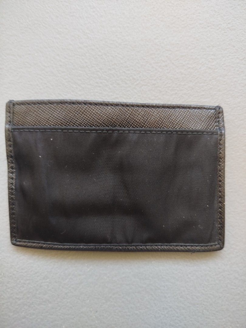 Prada Card Holder (Category: Luxury Bags & Wallets) located in Calamba. Submitted by merrymerida (Listing ID 1432290302, Image 2). Description: - Authentic Prada card holder - Color: Black - Features Prada logo and "MILANO" - Textured back design - Interior with card compartments - "MADE IN ITALY" marked.