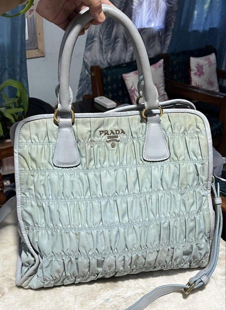 Prada Tessuto Gaufre Tote Bag Light Green (Category: Ear Care) located in Mandaue City. Submitted by chuchi152615 (Listing ID 1432307942, Image 1). Description: - Prada Tessuto Gaufre tote bag - Light blue color - Ruched design - Top handles and detachable shoulder strap - Prada logo lining and zipper closure - Gold-tone hardware - Prada logo on front - Made in Italy.