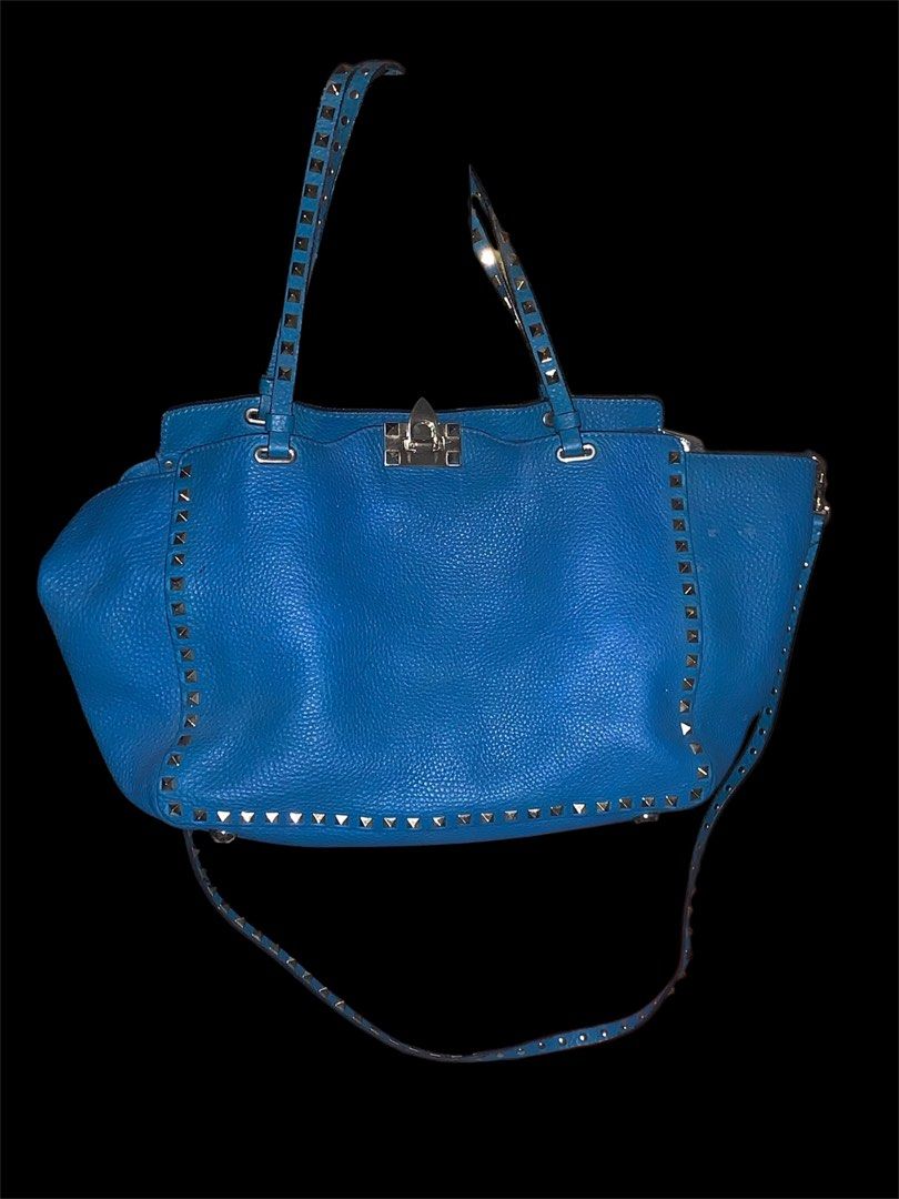 Valentino Rockstud Tote Bag (Category: Luxury Bags & Wallets) located in Muntinlupa City. Submitted by wanderluxesly (Listing ID 1432241742, Image 1). Description: - Valentino Rockstud tote bag - Stunning vibrant blue color - Iconic pyramid stud detailing - Dual top handles and detachable shoulder strap - Secure clasp closure - Crafted from textured leather.