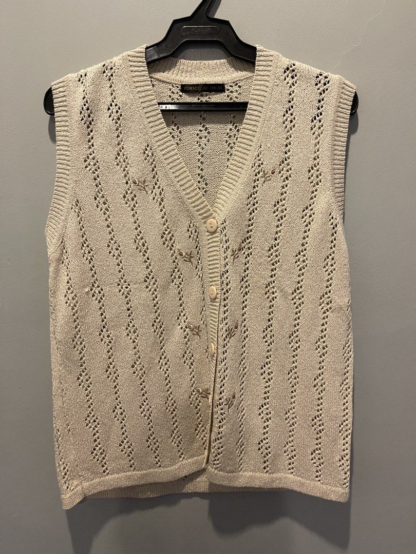 Vintage Beige Knit Vest (Category: Sleeveless) located in Muntinlupa City. Submitted by cheeeeky (Listing ID 1432291212, Image 1). Description: - Vintage beige knit vest - V-neck design - Button-down closure - Sleeveless - Decorative floral accents - Lightweight knit material - Ideal for layering - Classic, timeless style.