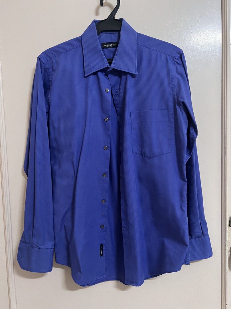 Wharson Blue Long Sleeve Shirt (Category: Tshirts & Polo Shirts ) located in Gasan. Submitted by lheese (Listing ID 1432345332, Image 1). Description: - Wharson long sleeve shirt - Blue with vertical stripes - Classic collar - Button-down closure - Chest pocket - Buttoned cuffs - Features a small tag - Ideal for smart casual wear.