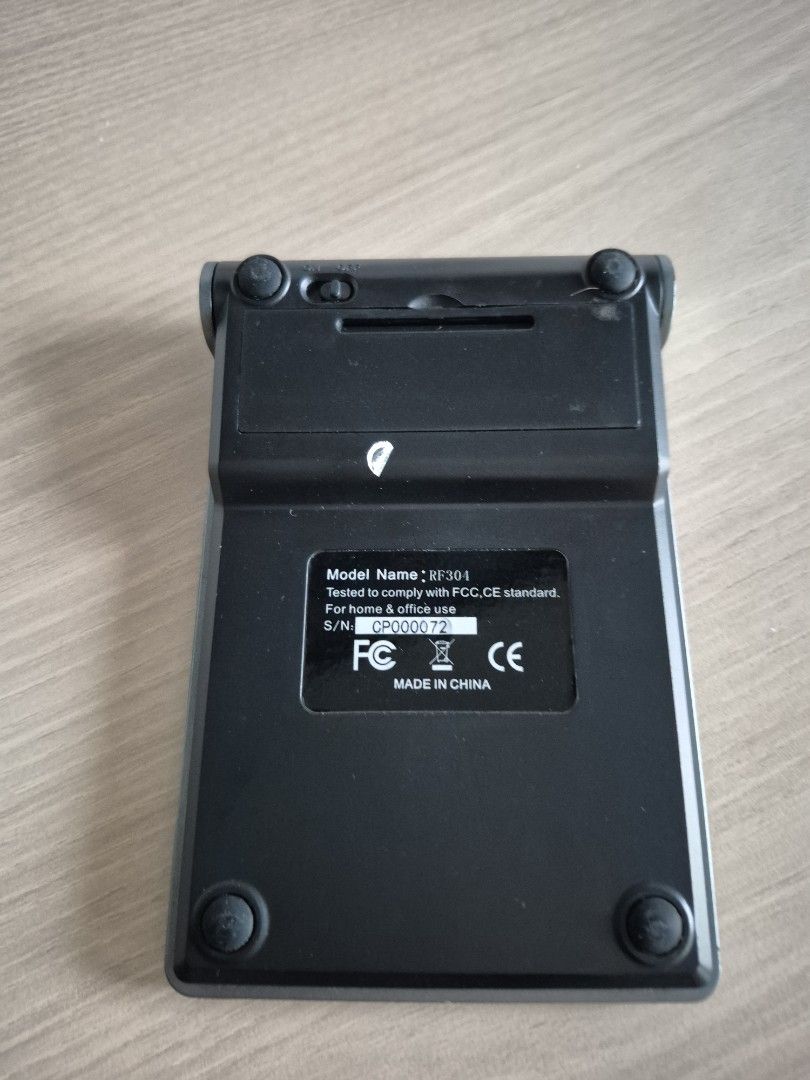 Wireless Numeric Keypad (Category: Computer Keyboard) located in Singapore. Submitted by nishiki2221 (Listing ID 1432300713, Image 2). Description: - Wireless numeric keypad - Grey finish with black keys - Model: RF304 - Includes backspace and function keys - Features a power switch.
