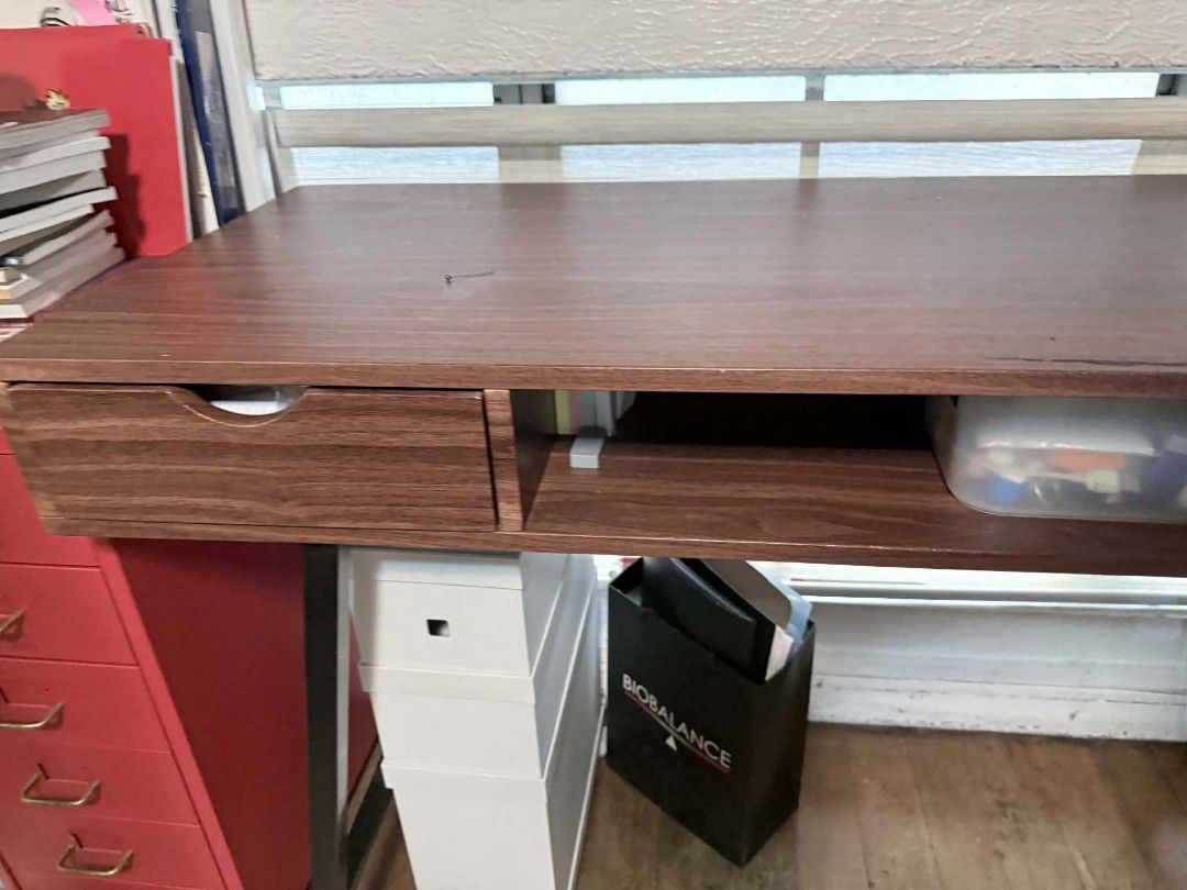 Wooden Desk with Drawers (Category: Tables & Sets) located in Manila. Submitted by happy.twinstars (Listing ID 1432203228, Image 2). Description: - Dark brown wooden desk - Features two drawers and an open shelf - Rectangular tabletop - Black metal legs - Sturdy construction - Sturdy wood - Perfect for home office or study - Provides ample workspace and storage Size: Height: 27 inches Width: 46.5inches Length: 16 inches pick up locatiom: Sta. Mes