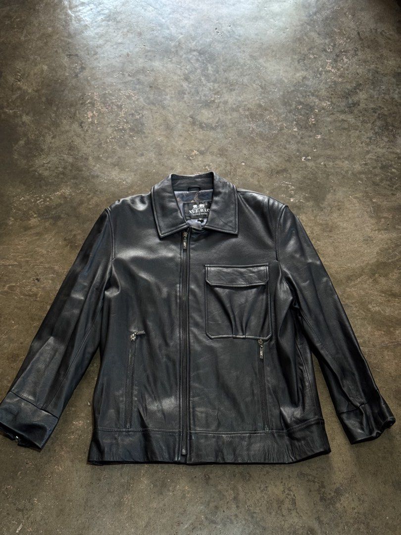 XUE BAO Leather Jacket (Chrome Hearts Vibes) (Category: Coats, Jackets and Outerwear) located in Quezon City. Submitted by jogs.05 (Listing ID 1432208674, Image 1). Description: - XUE BAO black leather jacket -Size: M-L (22W x 28L) - Collared neckline - Zip-up front - Multiple pockets - Sleeve zippers - Patterned lining .