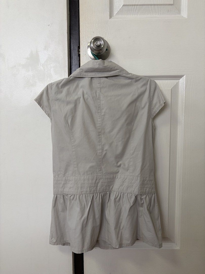Y2K Office siren style Blouse (Category: Blouses) located in Manila. Submitted by pauly2112 (Listing ID 1432261769, Image 2). Description: Really cute overlapping blouse. Has a built-in belt for a snatching effect. Thrifted from IG but never worn. Would keep but it doesn’t fit :( rfs: Declutter + too small mop: Gcash J&T and Lalamove available .