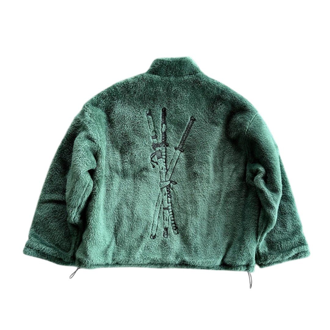 Zoro Jacket (Category: Coats, Jackets and Outerwear) located in Singapore. Submitted by previousaccgothacked (Listing ID 1432367708, Image 2). Description: - Green fleece jacket - Full zip closure - Embroidered design on back - Skull and crossbones on front - Patterned lining - Hidden pocket with "Nothing happened..." inscription.