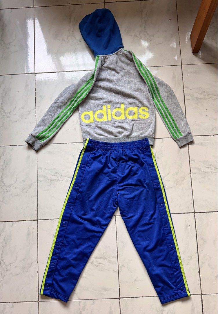Adidas Tracksuit Set - Grey and Blue (Category: Sets & Coordinates) located in Paranaque City. Submitted by crew08 (Listing ID 1432545524, Image 3). Description: - Adidas tracksuit set (SOLD AS SET) -Size 140 - Grey zip-up hoodie - Green stripes on sleeves - Blue hood - Matching blue track pants - Green stripes on sides - Snap closures - Adidas logo on jacket and pants Good condition,zipper and buttons smoothly working -Name stamp of my son at th