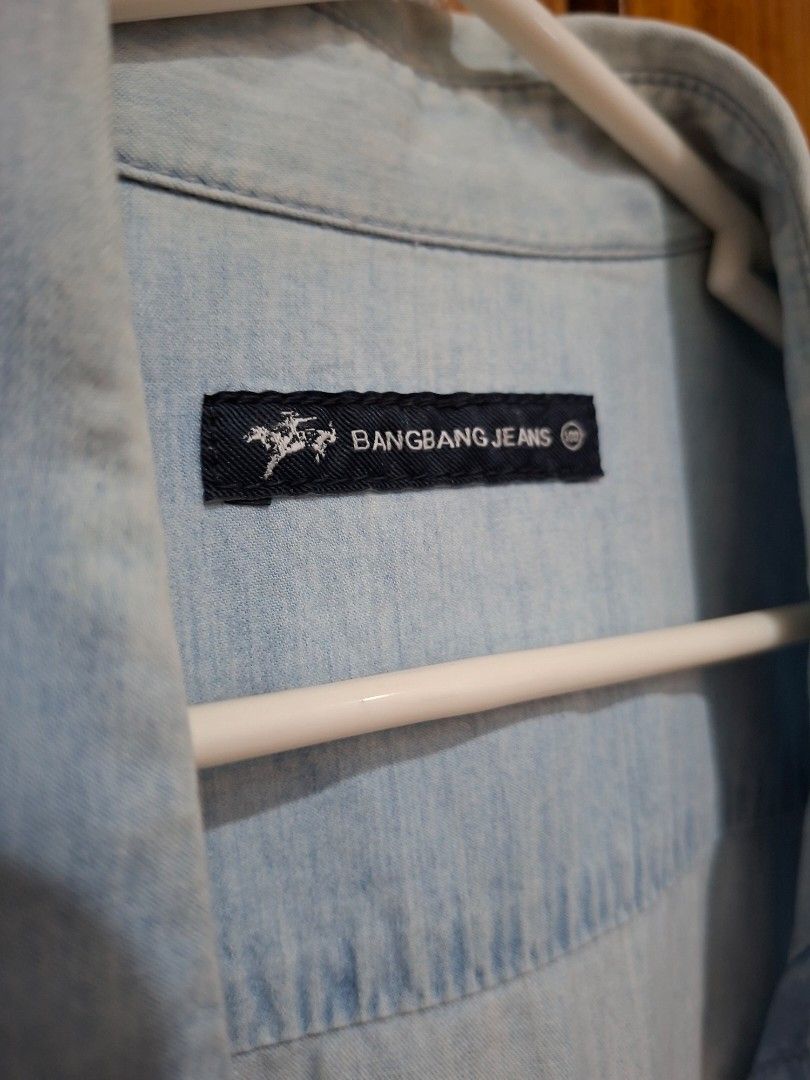 Bangbang Jeans Denim Shirt (Category: Tshirts & Polo Shirts ) located in Caloocan City. Submitted by mikomikoj (Listing ID 1432433939, Image 2). Description: - Light blue denim shirt - Brand: Bangbang Jeans - Short sleeves - Button-down front - Classic style - Versatile wardrobe piece MOD: Lalamove/J&T MOP: GCash/Maribank.