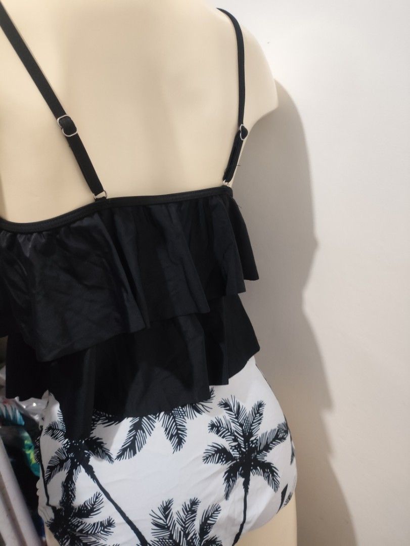 Black Ruffle Top with Palm Tree Bottoms (Category: Bikinis & Swimsuits) located in Pasay City. Submitted by neighbourhoodfinds (Listing ID 1432469405, Image 2). Description: - Black ruffle top with adjustable straps - Layered ruffle design on top - High-waisted bottom with palm tree print - Classic cut bottom - Ideal for beach or pool days.