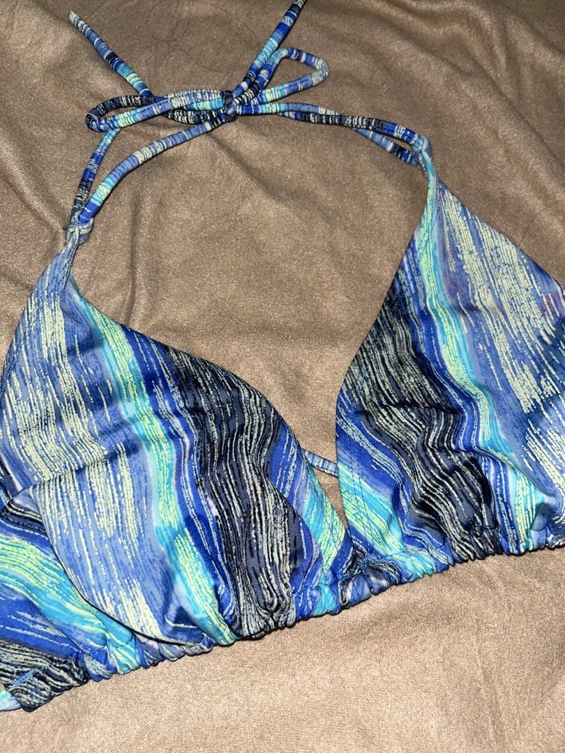 Blue Patterned Bikini Top (Category: Bikinis & Swimsuits) located in Manila. Submitted by quarishop21 (Listing ID 1432510197, Image 2). Description: - Blue and green patterned bikini top - Halter neck design - Adjustable ties - Triangle style - Minimal coverage - Smooth, likely synthetic material - Simple and stylish design.