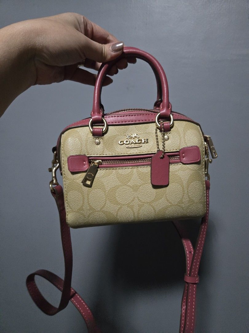 Coach Mini Rowan Bag (Category: Luxury Bags & Wallets) located in Bulacan. Submitted by row01 (Listing ID 1432558464, Image 2). Description: - Coach Mini Rowan Bag - Signature logo pattern with pink accents - Top handle and detachable shoulder strap - Zip closure - Interior pocket - Deep pink interior lining - Gold-toned hardware.