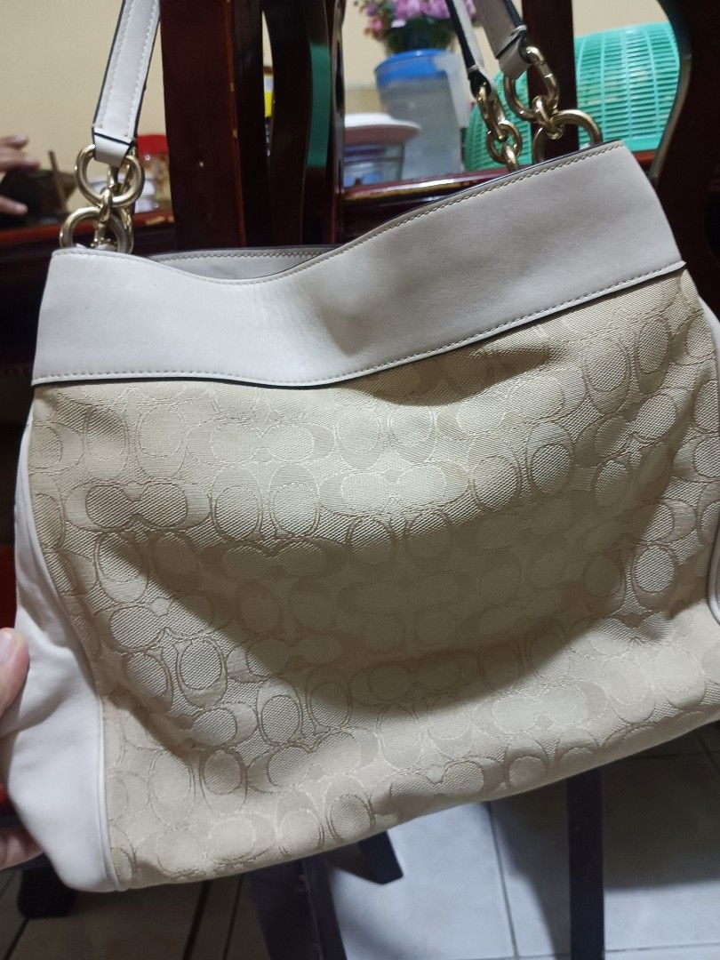 Coach Signature Shoulder Bag (Category: Luxury Bags & Wallets) located in Bacoor. Submitted by mms123mms (Listing ID 1432554320, Image 2). Description: - Coach shoulder bag - Signature pattern - Cream leather trim and handles - Gold-tone hardware - Interior zippered pocket - Coach leather tag - Spacious interior - Zip closure.