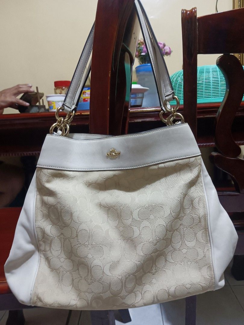 Coach Signature Shoulder Bag (Category: Luxury Bags & Wallets) located in Bacoor. Submitted by mms123mms (Listing ID 1432554320, Image 1). Description: - Coach shoulder bag - Signature pattern - Cream leather trim and handles - Gold-tone hardware - Interior zippered pocket - Coach leather tag - Spacious interior - Zip closure.