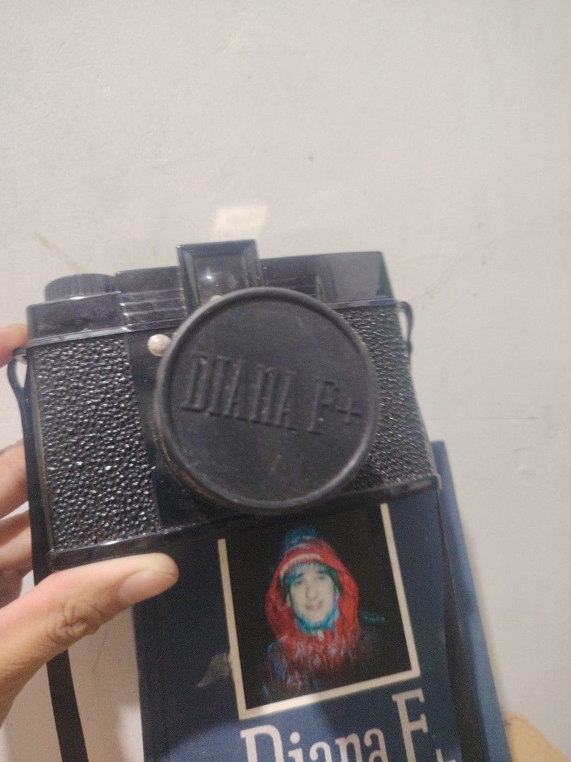 Diana F+ Camera and Book (Category: Cameras) located in Caloocan City. Submitted by beatfinds (Listing ID 1432524628, Image 1). Description: - Diana F+ camera (black body) included. - Comes with lens cap. - Includes the book "Diana F+ More True Tales & Short Stories" (blue cover)..