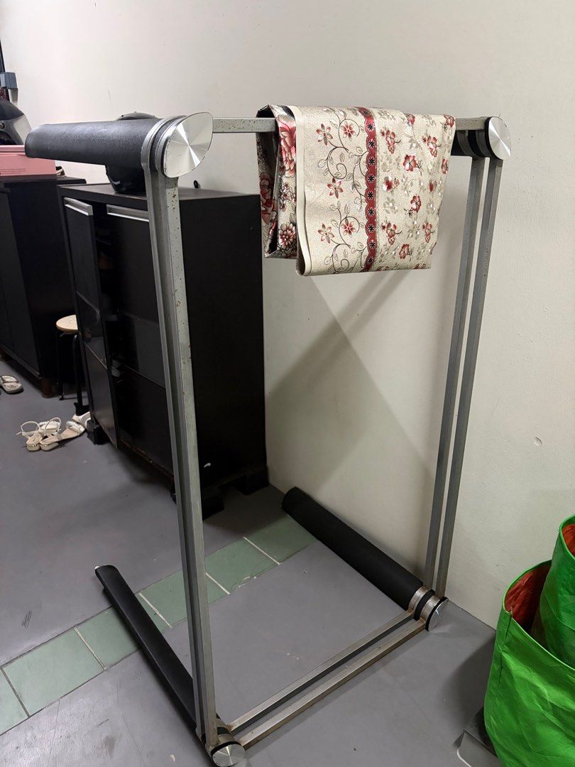 Dining table (Category: Clothes Drying Rack) located in Singapore. Submitted by xxjbgih (Listing ID 1432487063, Image 1). Description: - Dining table with steel frame - Features a glass tabletop - Modern design.