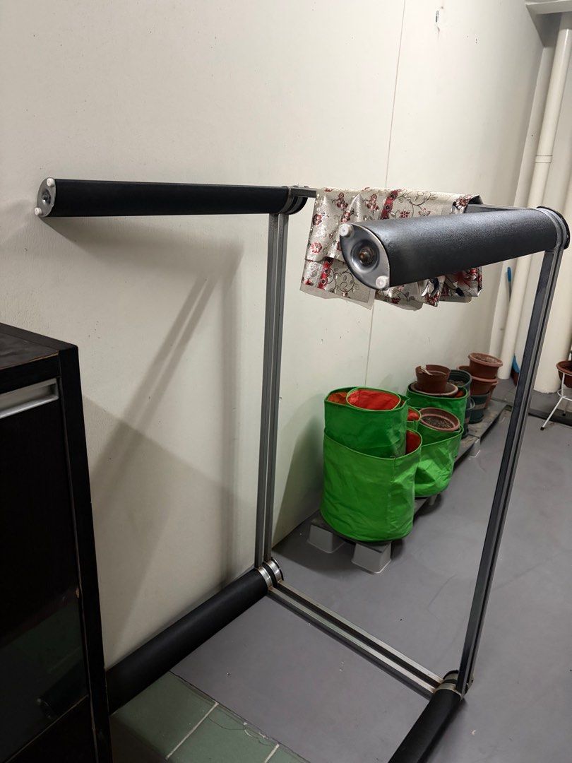 Dining table (Category: Clothes Drying Rack) located in Singapore. Submitted by xxjbgih (Listing ID 1432487063, Image 2). Description: - Dining table with steel frame - Features a glass tabletop - Modern design.