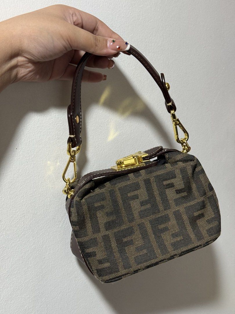 Fendi Mini Baguette Bag (Category: Luxury Bags & Wallets) located in Manila. Submitted by pink.lady_01 (Listing ID 1432492688, Image 1). Description: - Authentic Fendi Mini Baguette bag - Iconic FF logo pattern - Top handle and detachable strap - Gold-tone clasp closure and hardware - Interior zip closure - Includes small logo plate - Serial number tag included.
