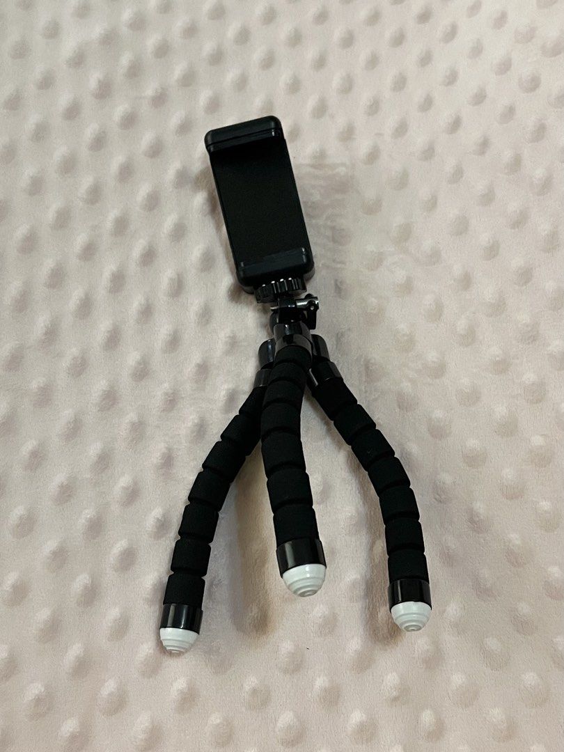 Japan Flexible Octopus Phone Tripod (Category: Mounts & Holders) located in Bulacan. Submitted by rks_closet (Listing ID 1432539011, Image 1). Description: RFS: Decluttering Lightweight and portable mini phone tripod, perfect for vlogging, online meetings, TikTok videos, and hands-free watching. Flexible legs for easy positioning on tables, beds, or uneven surfaces. Strong grip holds most smartphones securely. Compact design – easy to bring anywh