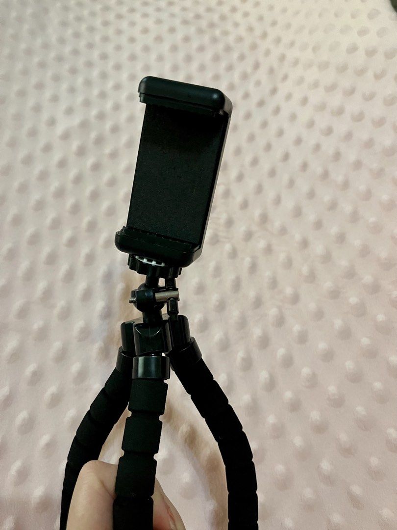 Japan Flexible Octopus Phone Tripod (Category: Mounts & Holders) located in Bulacan. Submitted by rks_closet (Listing ID 1432539011, Image 2). Description: RFS: Decluttering Lightweight and portable mini phone tripod, perfect for vlogging, online meetings, TikTok videos, and hands-free watching. Flexible legs for easy positioning on tables, beds, or uneven surfaces. Strong grip holds most smartphones securely. Compact design – easy to bring anywh