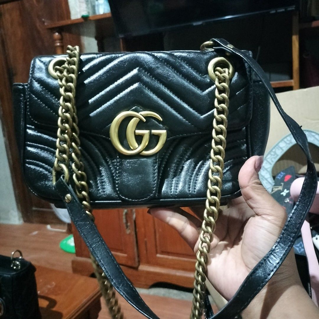Gucci GG Marmont Mini Bag Black (Category: Luxury Bags & Wallets) located in Manila. Submitted by swifthawk-cfc412 (Listing ID 1432535742, Image 1). Description: - Authentic Gucci GG Marmont Mini Bag - Classic black chevron design - Gold-tone chain strap - Iconic GG logo on the front - Heart-shaped design on the back - Flap closure - Interior includes a small pocket with Gucci label.