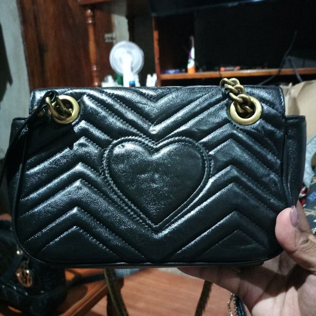 Gucci GG Marmont Mini Bag Black (Category: Luxury Bags & Wallets) located in Manila. Submitted by swifthawk-cfc412 (Listing ID 1432535742, Image 2). Description: - Authentic Gucci GG Marmont Mini Bag - Classic black chevron design - Gold-tone chain strap - Iconic GG logo on the front - Heart-shaped design on the back - Flap closure - Interior includes a small pocket with Gucci label.
