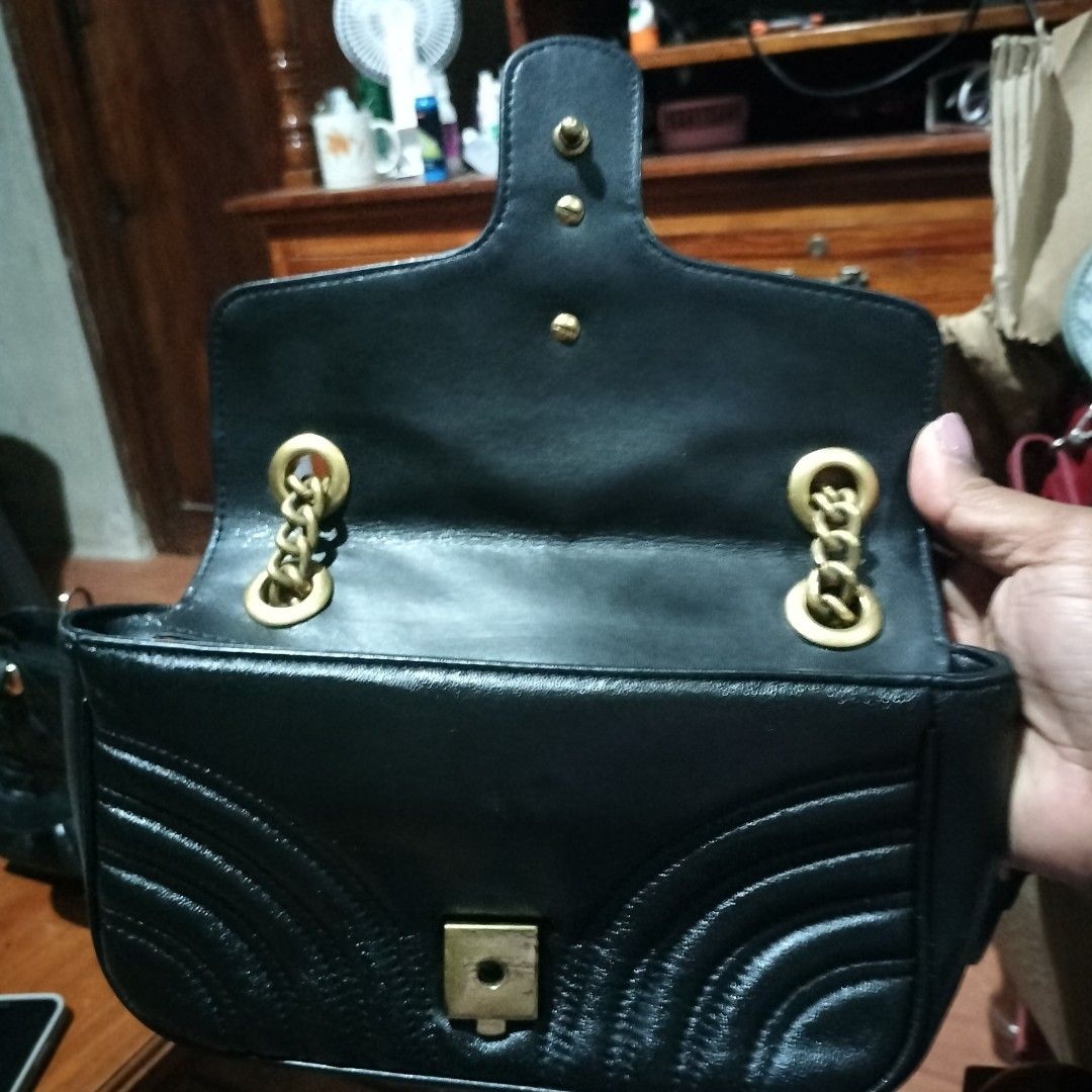 Gucci GG Marmont Mini Bag Black (Category: Luxury Bags & Wallets) located in Manila. Submitted by swifthawk-cfc412 (Listing ID 1432535742, Image 3). Description: - Authentic Gucci GG Marmont Mini Bag - Classic black chevron design - Gold-tone chain strap - Iconic GG logo on the front - Heart-shaped design on the back - Flap closure - Interior includes a small pocket with Gucci label.