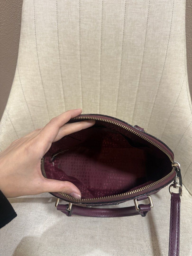 Kate Spade Dome Crossbody Bag (Category: Cross-body Bags) located in Taguig. Submitted by anmit (Listing ID 1432398710, Image 2). Description: - Kate Spade crossbody bag - Dome shape - Top handle - Zip closure - Detachable shoulder strap - Deep burgundy color - Lined interior - Small Kate Spade logo.