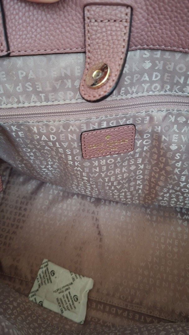 Kate Spade Pink Handbag with Shoulder Strap (Category: Luxury Bags & Wallets) located in Mandaluyong City. Submitted by lgonz (Listing ID 1432512176, Image 3). Description: - 100% Authentic; full leather - No issues, no scratches - Like new, gently used for about 3 times only - Beautiful pink color - Detachable shoulder strap - Top handle - Bow detail on the front - Patterned interior lining - Small interior pocket - Protective metal feet - Inclu