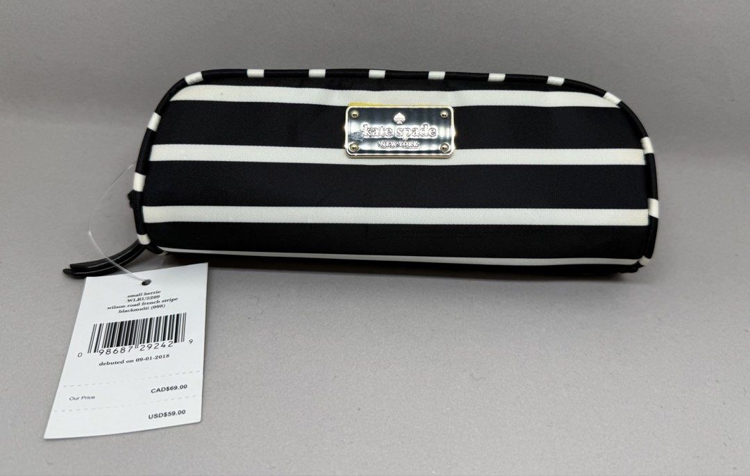 Kate Spade Small Berrite Cosmetic Bag (Category: Luxury Bags & Wallets) located in Quezon City. Submitted by d.othersetc (Listing ID 1432509142, Image 1). Description: - Authentic Kate Spade cosmetic bag - Black and white stripe design - Gold-toned zipper and hardware - Includes original tags with CAD and USD price - Black interior with care card - Small, rectangular shape.