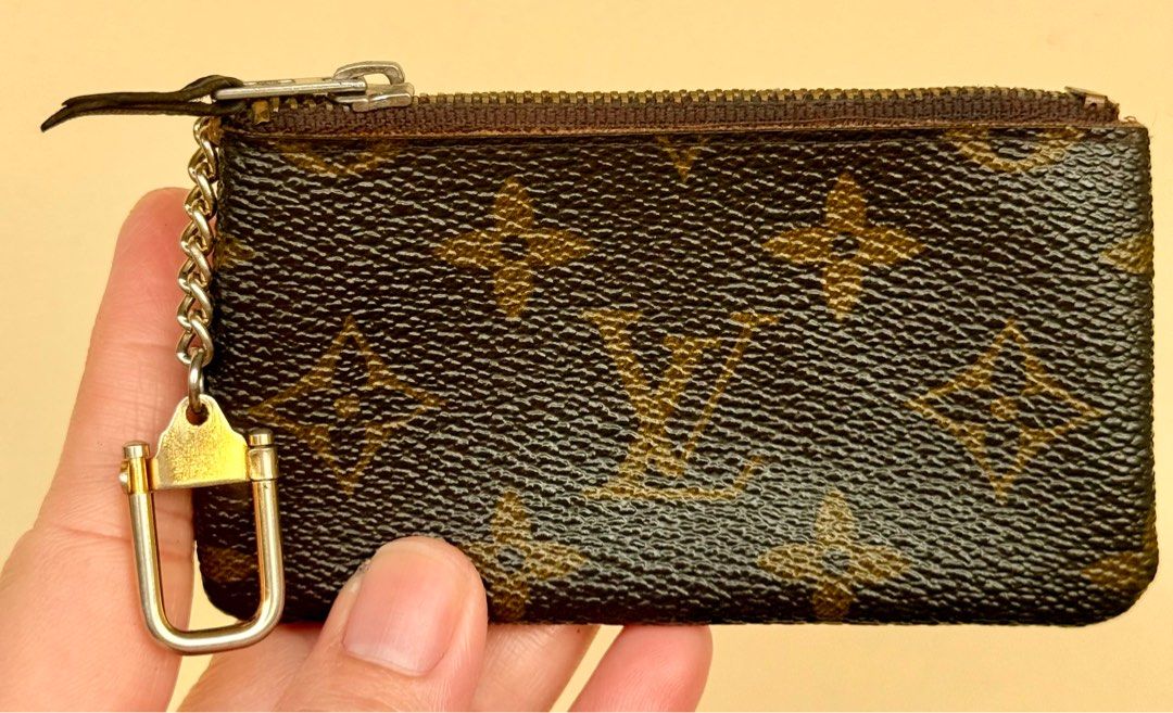 Louis Vuitton Monogram Coin Purse/ Key Pouch (Category: Luxury Bags & Wallets) located in Paranaque City. Submitted by lyn0618 (Listing ID 1432495692, Image 3). Description: FOR SALE! AUTHENTIC LOUIS VUITTON KEY POUCH/ COIN PURSE PRE LOVED. ITEM. HAS SIGN OF WEAR INSIDE ECLAIR. ZIPPER NO CODE. VINTAGE COIN PURSE - Authentic Louis Vuitton key pouch - Monogram canvas - Zip closure - Chain with clasp - Brown leather interior - 'ECLAIR' zipper markin