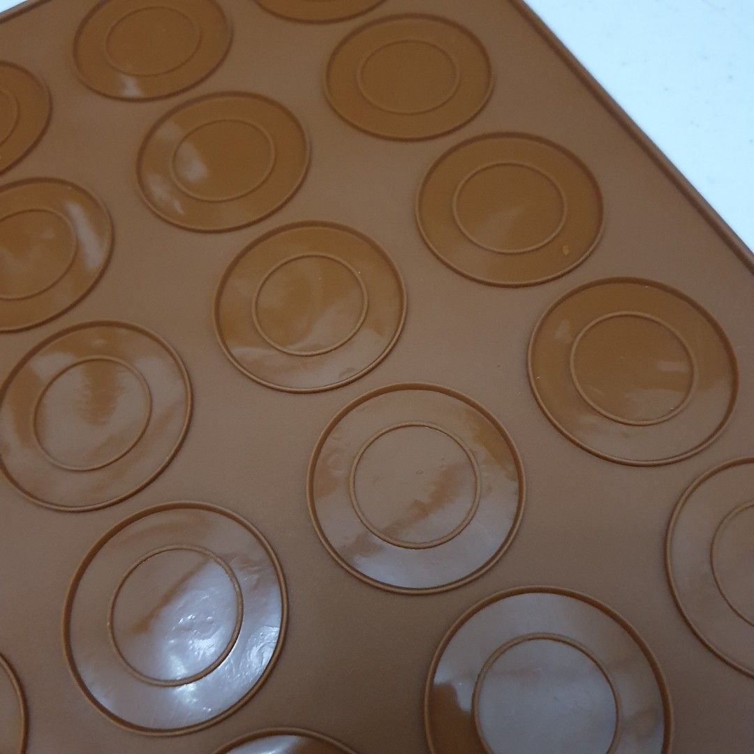 Silicone Macaron Baking Mat mold (Category: Bakeware) located in Paranaque City. Submitted by cobien (Listing ID 1432547410, Image 3). Description: - Silicone macaron baking mat - Pre-formed circles for perfect macaron placement - Measures 11.5 x 8.5 inches - Flexible and non-stick material - Easy removal of baked goods - Brown color.