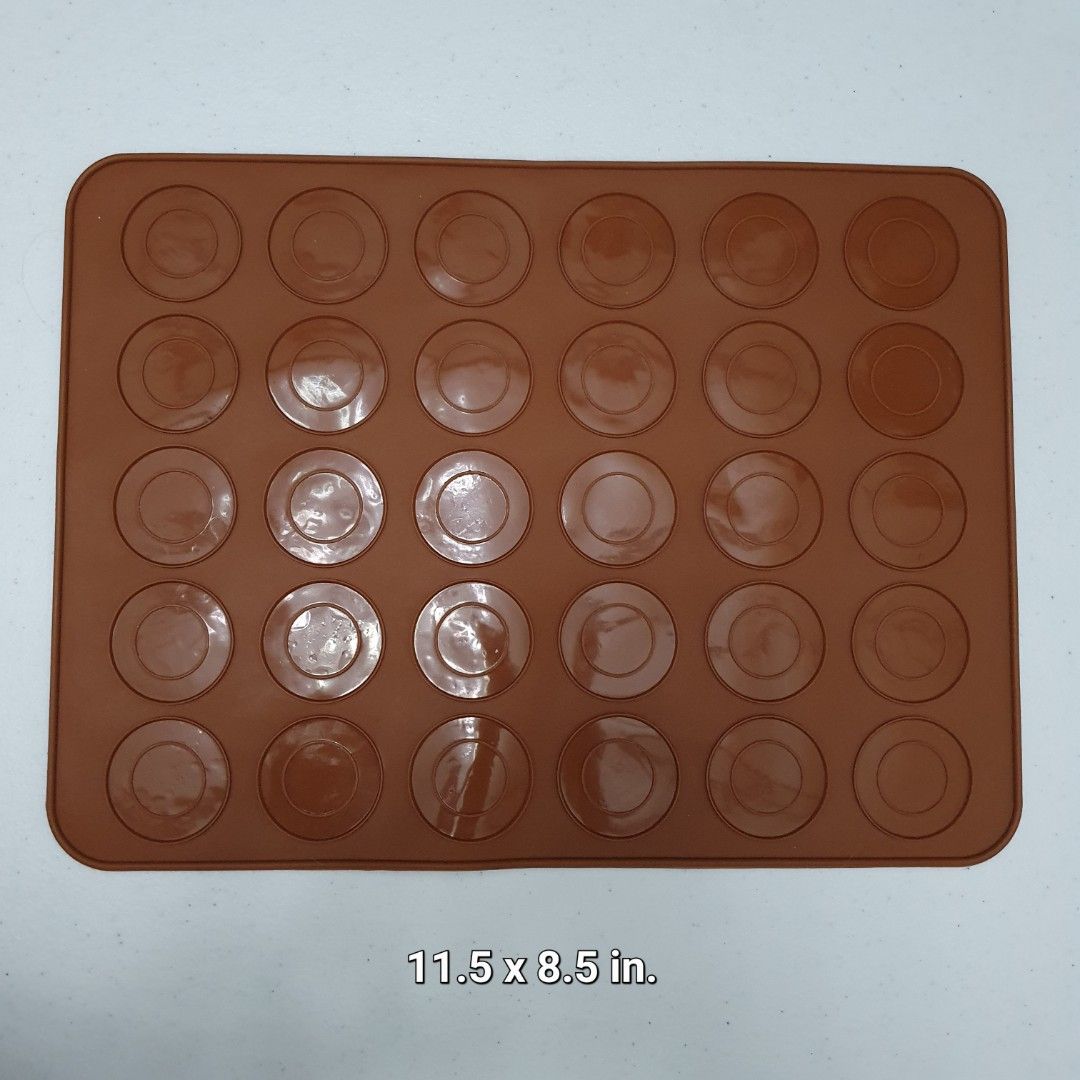 Silicone Macaron Baking Mat mold (Category: Bakeware) located in Paranaque City. Submitted by cobien (Listing ID 1432547410, Image 1). Description: - Silicone macaron baking mat - Pre-formed circles for perfect macaron placement - Measures 11.5 x 8.5 inches - Flexible and non-stick material - Easy removal of baked goods - Brown color.