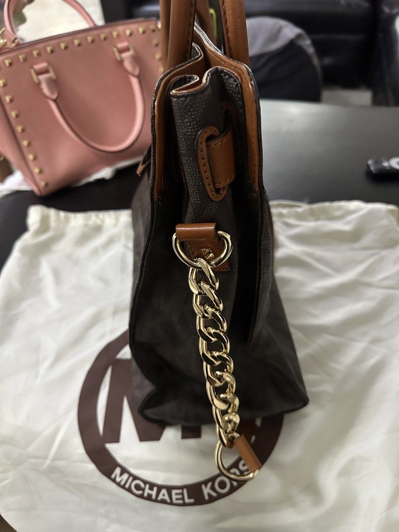 Michael Kors Handbag with Dust Bag (Category: Luxury Bags & Wallets) located in Bulacan. Submitted by mommysuki (Listing ID 1432395541, Image 3). Description: - Authentic Michael Kors handbag - Brown monogram pattern - Tan leather accents - Gold-tone chain strap - Includes dust bag - Multiple interior compartments - Secure lock closure with MK logo - Ideal for everyday use.